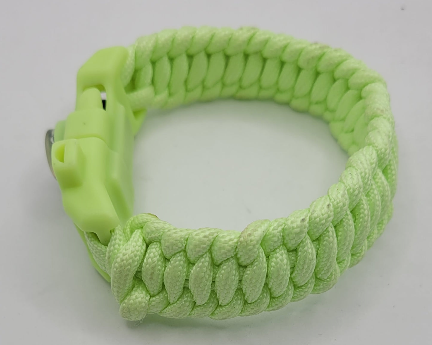 The Glow In Dark green paracord bracelet with a tool Buckle.