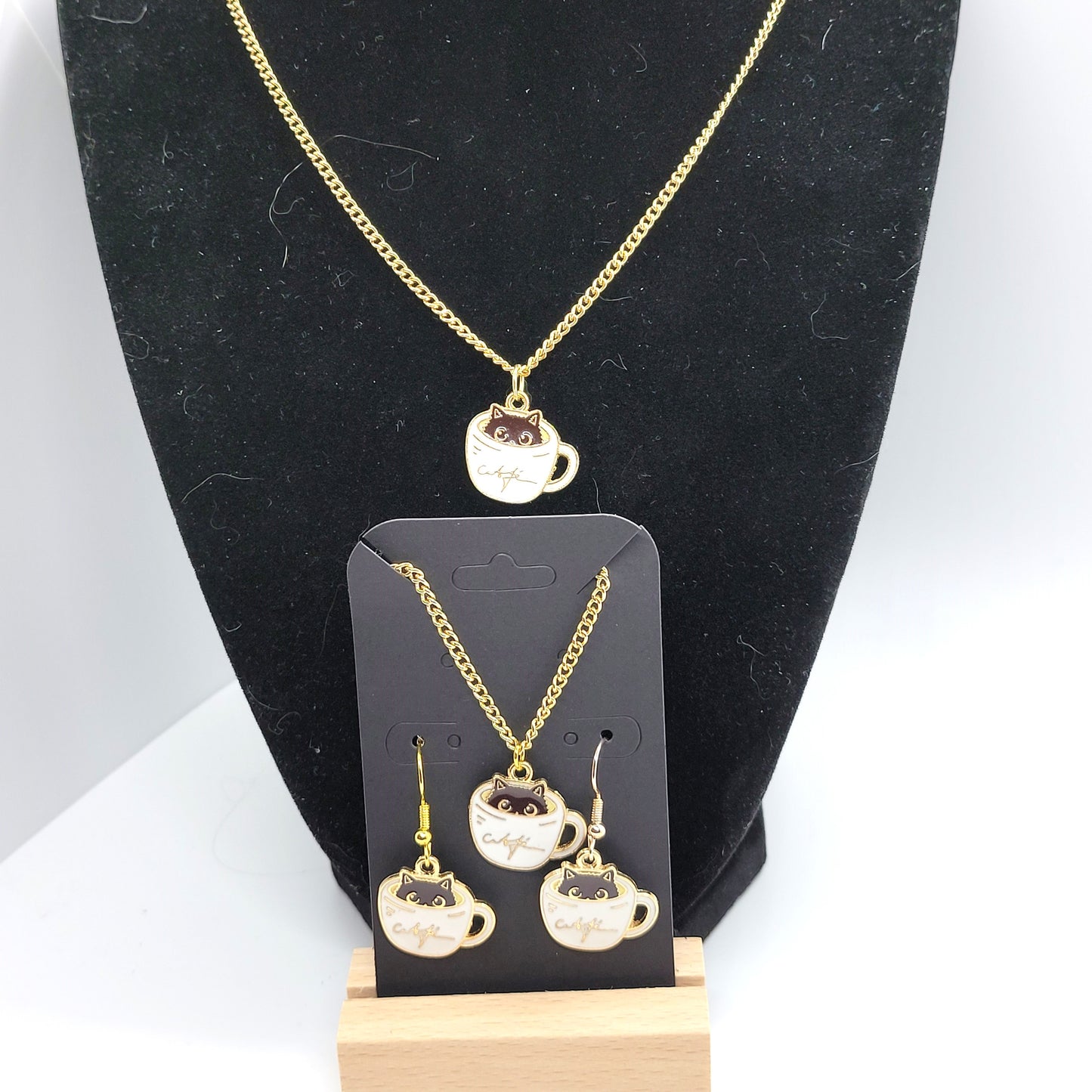 Black cat peeking out of white cup of coffee, Handcrafted Dangle earring, bracelet, necklace set, gold toned.