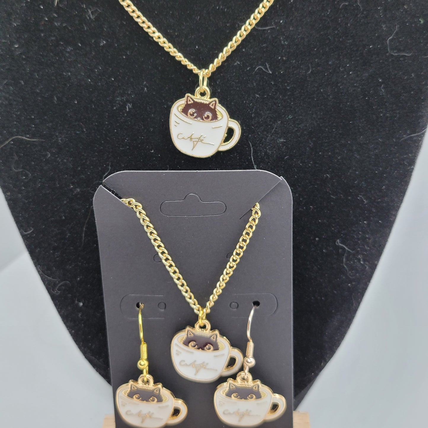 Black cat peeking out of white cup of coffee, Handcrafted Dangle earring, bracelet, necklace set, gold toned.