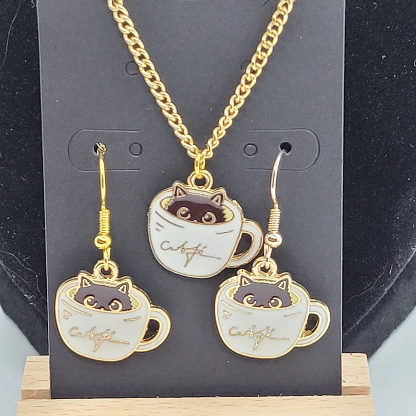 Black cat peeking out of white cup of coffee, Handcrafted Dangle earring, bracelet, necklace set, gold toned.