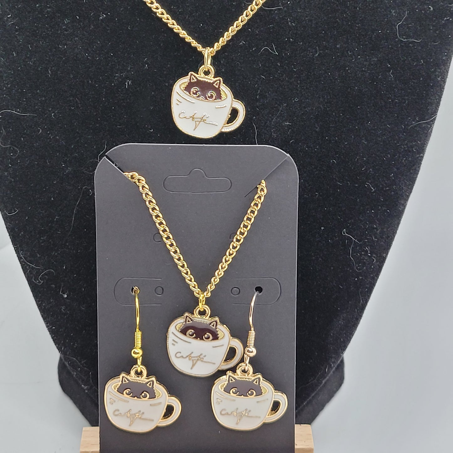 Black cat peeking out of white cup of coffee, Handcrafted Dangle earring, bracelet, necklace set, gold toned.